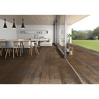 Thumbnail image of Indoor/outdoor patio area with porcelain floor tile in large profile stacked and warm tones and a metallic finish adding a industrial feel to this modern area.